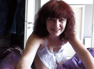 Incredible redhead mom sucks and penetrates herself in a couple of different positions.